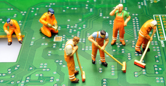 miniature people cleaning motherboard